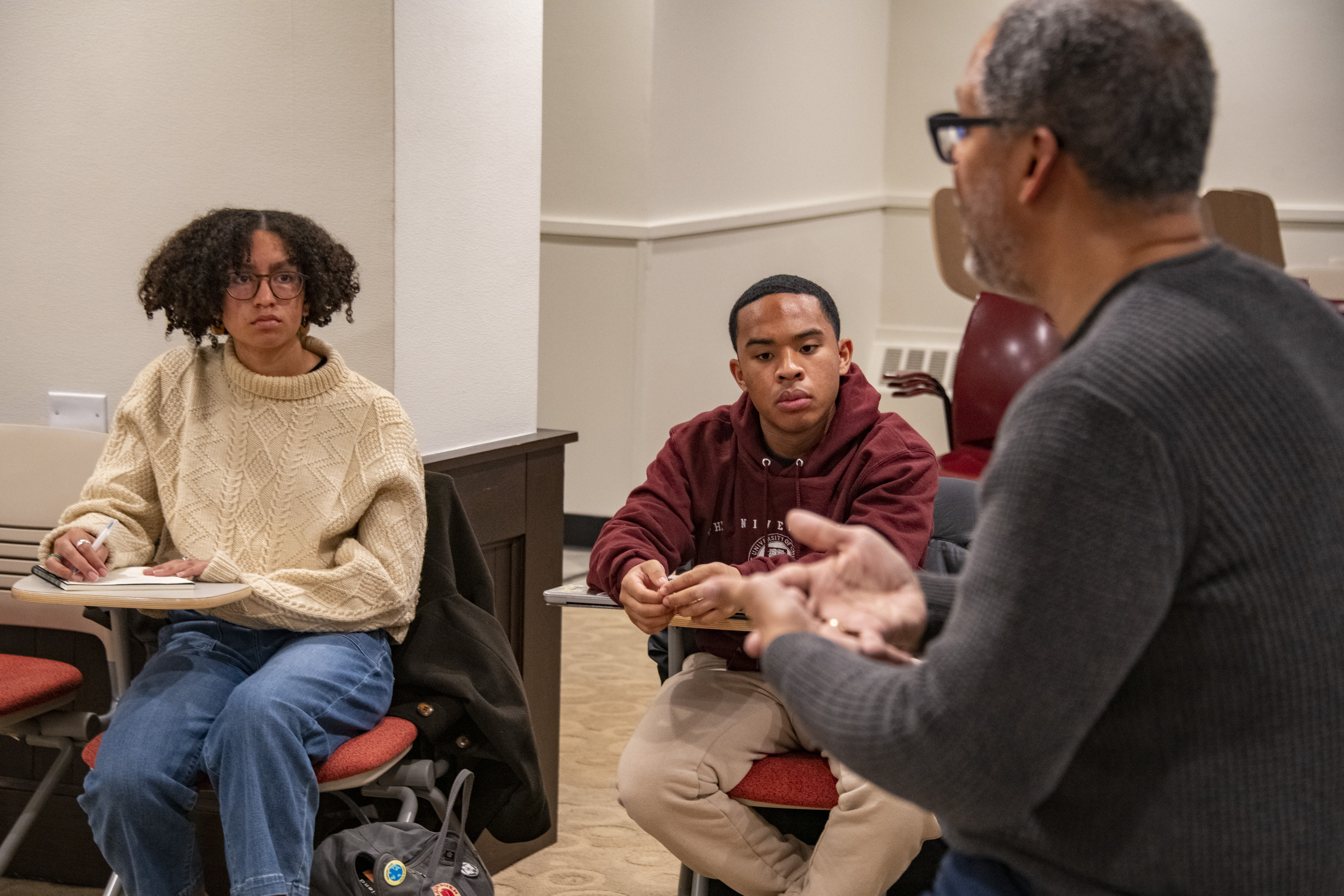 Photo of UChicago students and faculty engaged in a discussion