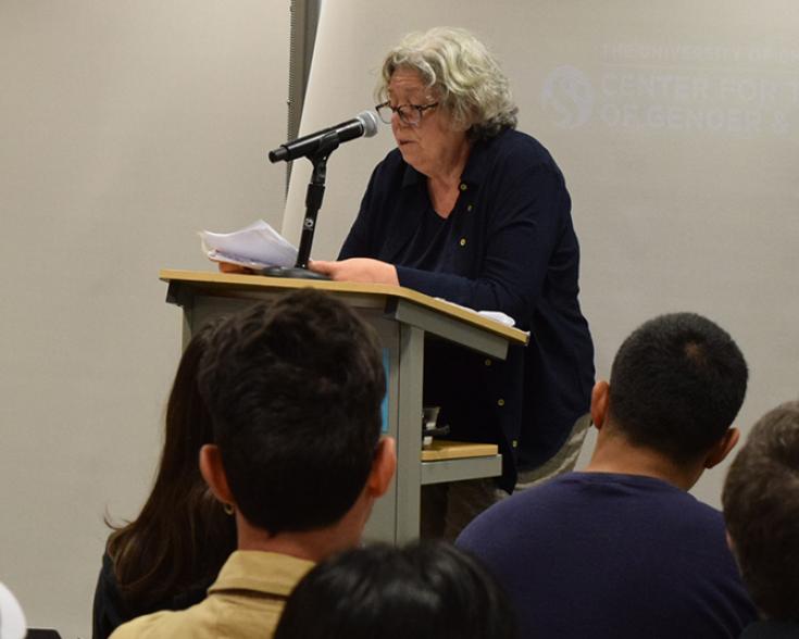 People seated listening to a speaker.