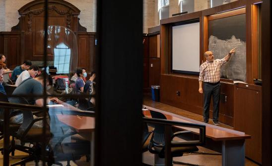 Victor Lima teaching an economics course in Saieh Hall.